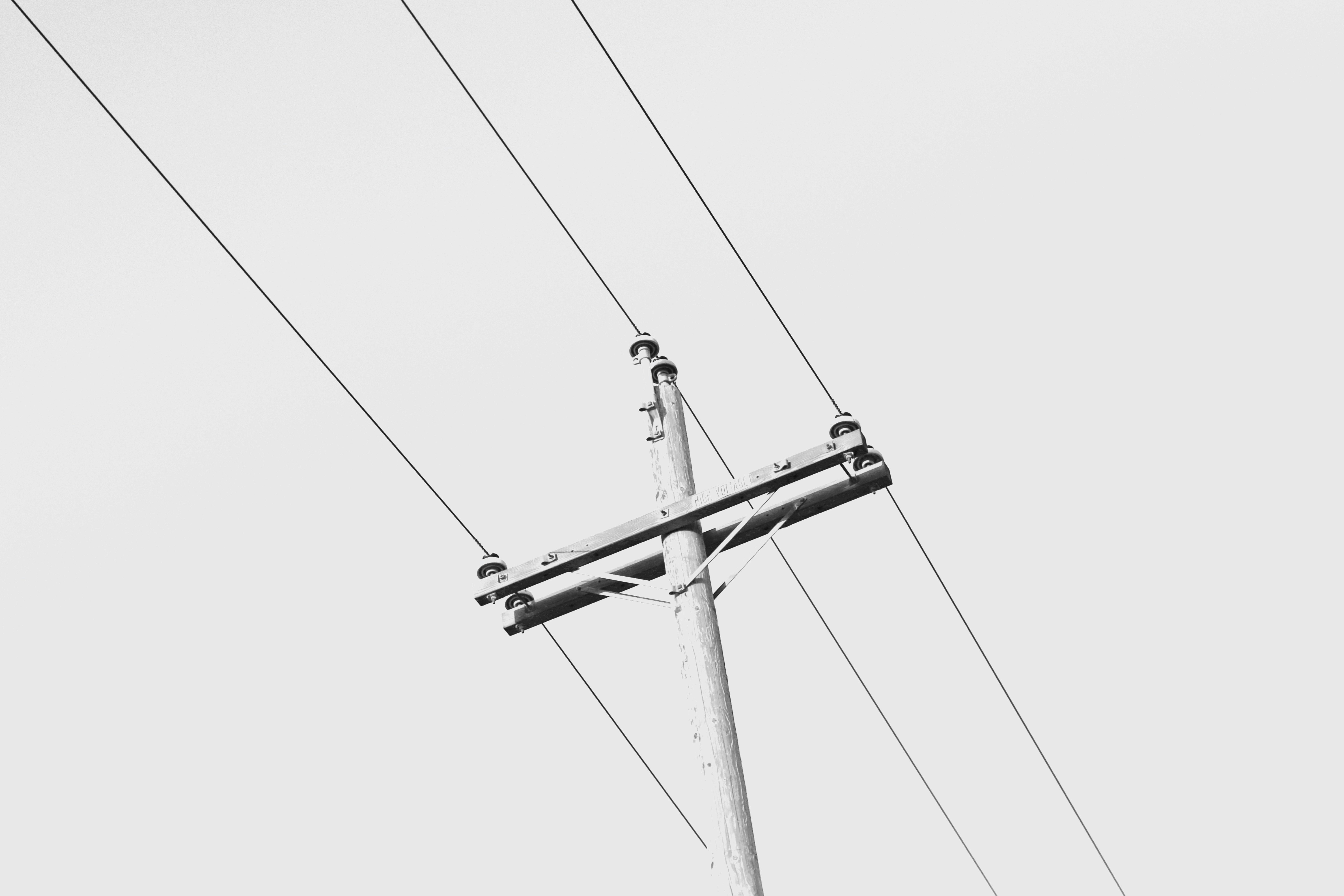 low-angle photography of grey electric post